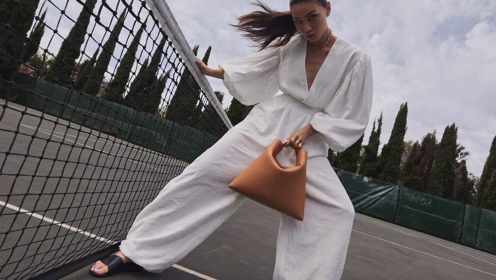 Dynamic editorial fashion scene on a tennis court